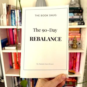 The 90-Day Rebalance Journal book held up against full bookshelf